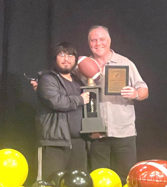 Gio Aguirre, recipient of the 2024 Kevin Werk award, pictures with Don Maroney of the AHS Football Alumni